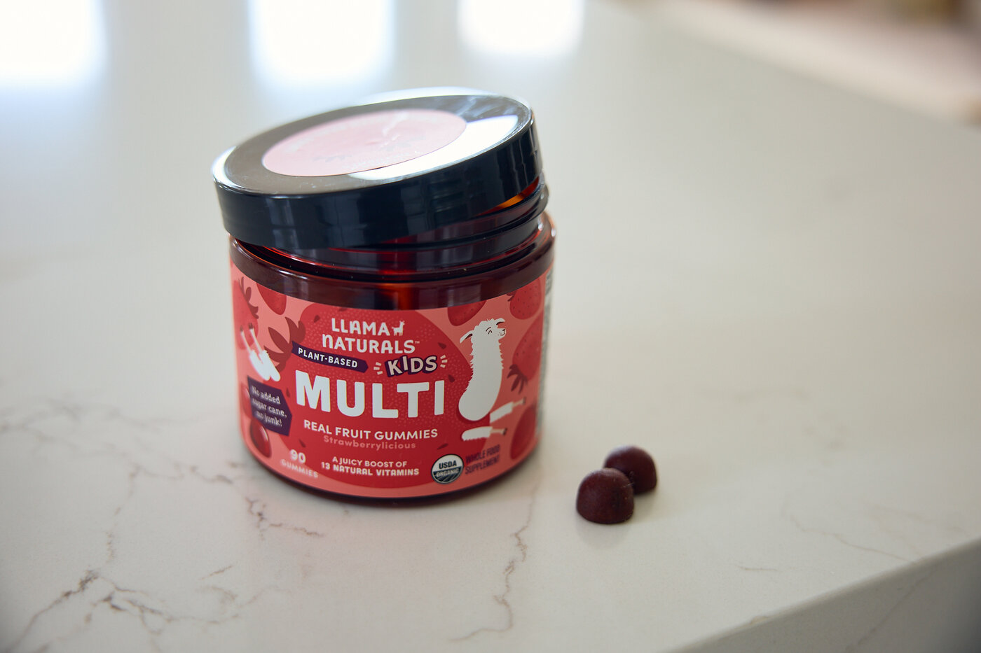 Llama Naturals Kids Multivitamin Gummies jar on the counter