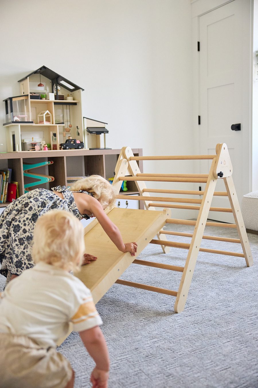 Emery and Ellison climbing and sliding down the Tiny Land Pikler Triangle 7-in-1 Montessori Climbing Set